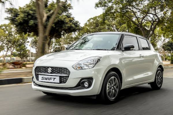 White Suzuki Swift sedan from the AV Travels fleet
