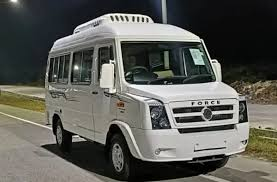 White Force Tempo Traveller 17 seater from the AV Travels fleet parked at night
