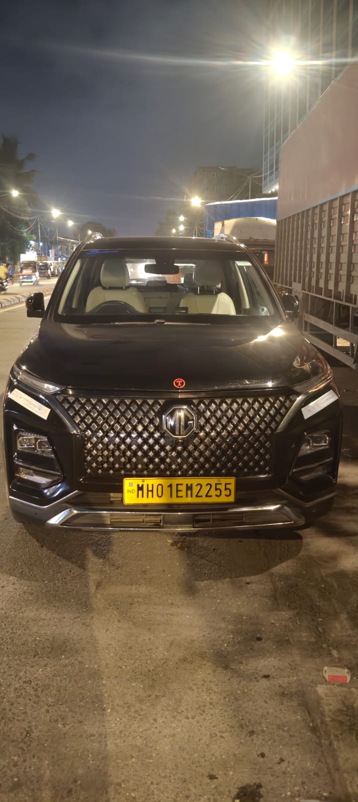 Black MG Hector premium SUV for travel with a commercial yellow plate