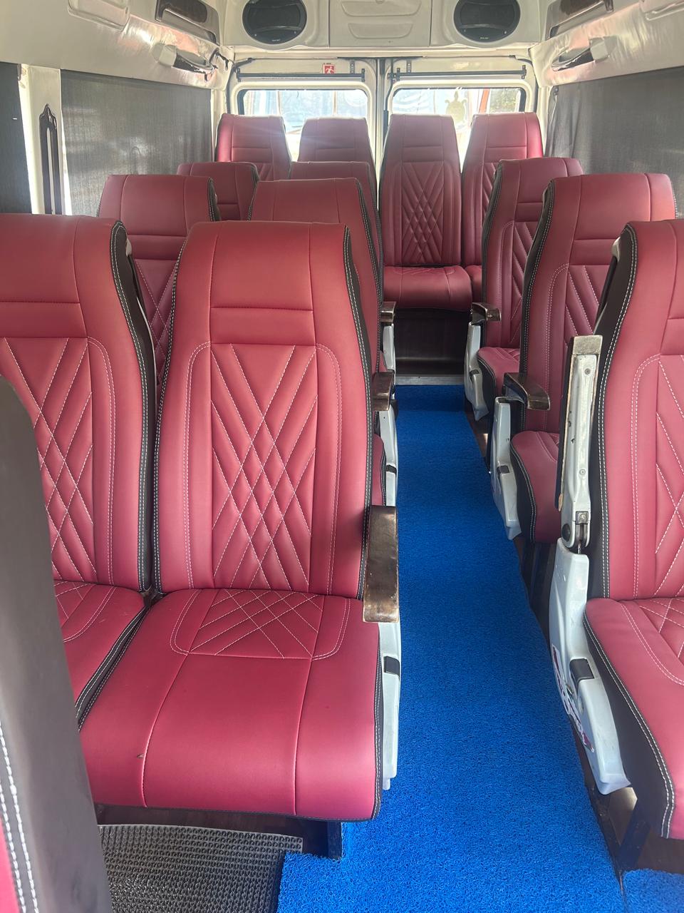 Tempo traveller interior with maroon push back seats for group travel