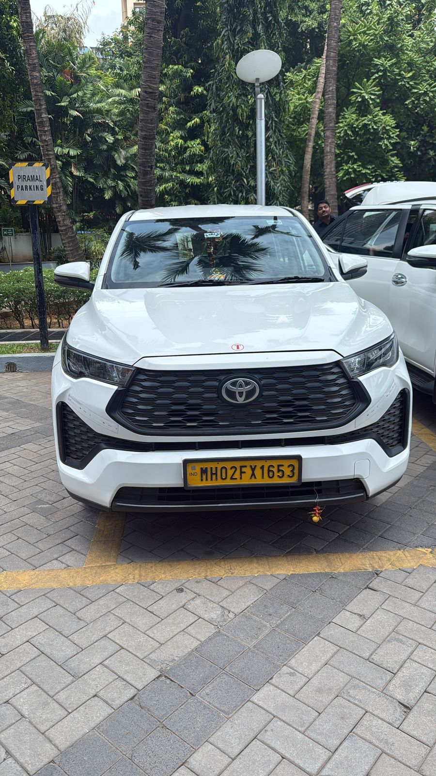 White Toyota Innova Crysta with commercial yellow plate parked in Mumbai