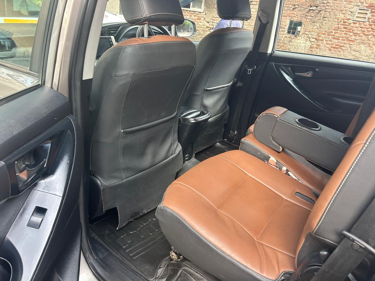 Innova Crysta rear seats in tan and black leatherette for family travel